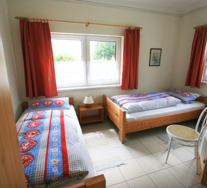 Helles Schlafzimmer mit zwei Einzelbetten in der Ferienwohnung in Zwiesel Schlafzimmer der Ferienwohnung Wernerhäusl mit zwei gemütlichen Einzelbetten für erholsame Nächte